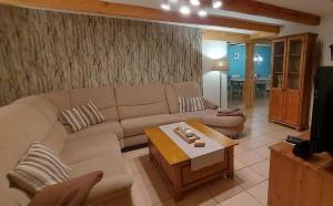 a living room with a couch and a coffee table at Große Strandperle in Fehmarn