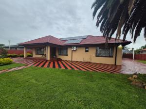a house with solar panels on the roof at Ithonsi Guesthouse in Kempton Park