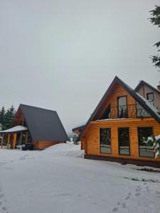 a log cabin with snow on the ground at Evergreen cabins Golija in Golija