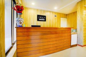 Un mostrador con un jarrón de flores encima. en Palette by CheckIn Igatpuri Formerly Bodh Valley Resort, en Igatpuri