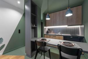 a kitchen with two chairs and a table in a room at Corto Maltese Boutique in Athens