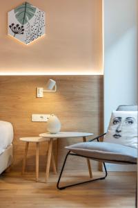 a bedroom with a table and a chair and a bed at Corto Maltese Boutique in Athens +97 photos