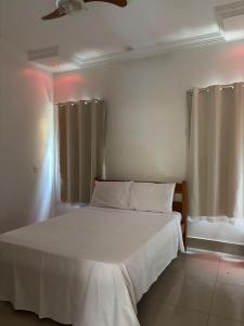 Ένα ή περισσότερα κρεβάτια σε δωμάτιο στο Cantinho Abençoado