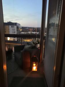 a candle on a balcony with a view of a city at Huoneisto järvinäkymin, Palokka in Jyväskylä