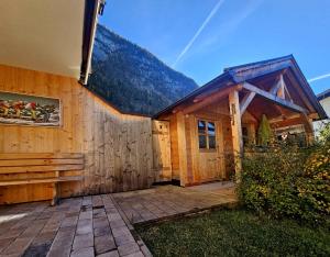 a wooden house with a patio in front of it at Puitbach Chalet in Leutasch