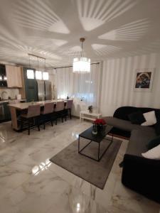 a living room with a couch and a table at Apartman Novska Noemi in Novska