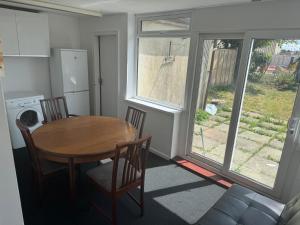 een keuken met een tafel en stoelen en een tafel en raam bij The Lantern in Bristol