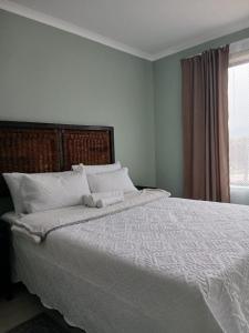 Postel nebo postele na pokoji v ubytování Bossi Lodge