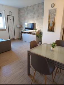 a living room with a table and chairs in a room at Home OKSY in Cavalcaselle
