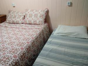 a small bedroom with a bed and a pillow at Casa de praia in Arroio do Sal