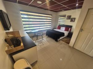a bedroom with a bed and a table in a room at Ithonsi Guesthouse in Kempton Park