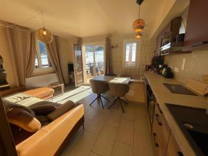 a kitchen with a couch and a table in it at Le Logis de Bamby in Ancelle +22 photos
