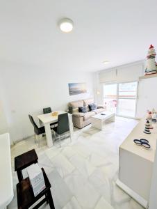 a living room with a couch and a table at Laguna Beach 15 Primera linea de Playa in Morche