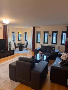 een woonkamer met een bank en een tafel bij Aquae Lux apartment in Sarajevo