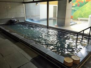 a large pool of water in a building at Breezbay Hotel & Resort Gero in Gero