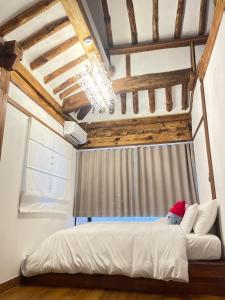 a bedroom with a bed with a santa hat on it at Hanok Hyeyum in Jeonju