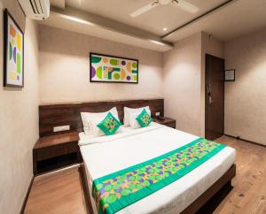 une chambre avec un grand lit dans une pièce dans l'établissement Treebo Awadhvue, à Indore 38 autres photos