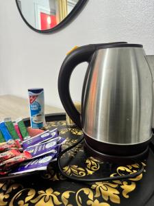 a tea kettle sitting on a table with toothpaste at Divin Appart in Abidjan +6 photos
