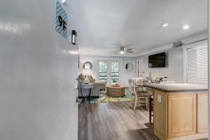 a kitchen and living room with white walls and a table at Fernandina Beach Hidden Gem - Amelia Landings - 9F in Fernandina Beach