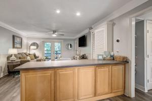 a kitchen with a large counter and a living room at Fernandina Beach Hidden Gem - Amelia Landings - 9F in Fernandina Beach