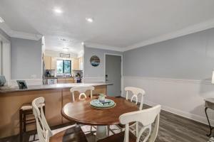 a kitchen and dining room with a table and chairs at Fernandina Beach Hidden Gem - Amelia Landings - 9F in Fernandina Beach +21 photos