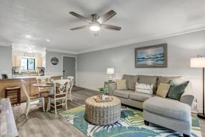 a living room with a couch and a table at Fernandina Beach Hidden Gem - Amelia Landings - 9F in Fernandina Beach