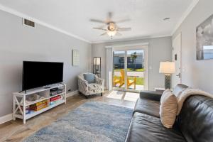 a living room with a couch and a flat screen tv at Tranquil Beach Retreat - Fernandina Shores 6398 in Fernandina Beach