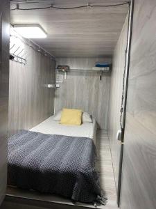 a small bedroom with a bed in a trailer at Personal Room Central in Chişinău