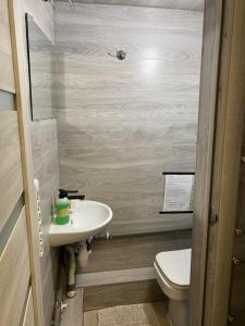 a small bathroom with a sink and a toilet at Personal Room Central in Chişinău
