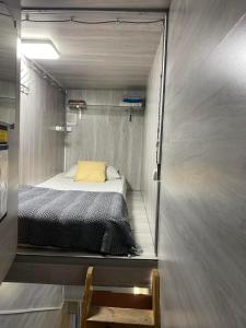 a small bedroom with a bed in a trailer at Personal Room Central in Chişinău