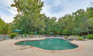 a swimming pool in a yard with chairs and umbrellas at Fins Up Margaritaville 2BD3BALoftGrillFirepit in Osage Beach