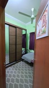 a bedroom with a bed in a room with a ceiling at The Nook Housestay in Ketereh