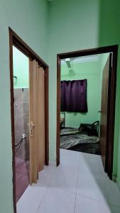 an open door to a room with a bathroom at The Nook Housestay in Ketereh +16 photos