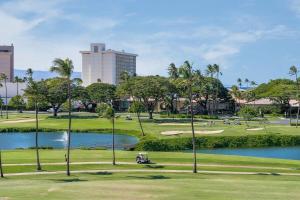 a golf course with a pond and palm trees at Kaanapali Royal D302 · KRL D302 Updated Kaanapali 2BD on Golf Co in Lahaina