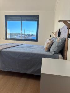 a bedroom with a bed and a large window at Origen Bed and Breakfast in Villargordo del Cabriel