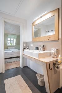 een badkamer met een wastafel en een spiegel bij Altes Rathaus in Schwaigern
