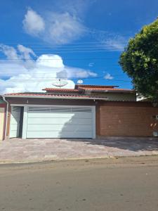a garage with two white garage doors on a house at Cantinho Abençoado in Pirenópolis +23 photos