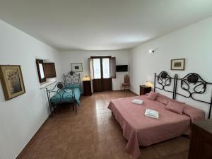 a bedroom with a bed and a couch in a room at B&B Casa Lydia in Lamezia Terme