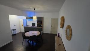 a kitchen and dining room with a table and chairs at Villa Fatjo in Le Tampon