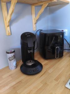 a coffee maker sitting on a counter next to a toaster at La Collinette in Saint-Laurent-du-Cros