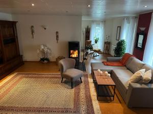 a living room with a couch and a table at Ferienwohnung Riva in Kronau