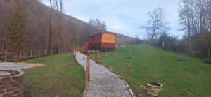 a red building on a hill in a field at Bambolina in Marche-en-Famenne