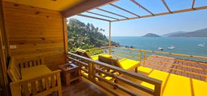 a room with a balcony with a view of the ocean at Pacific Sunset View Palolem in Palolem