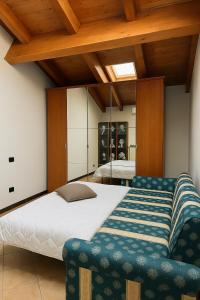 a bedroom with a large bed and a chair at Trevisan in Cerea +39 photos