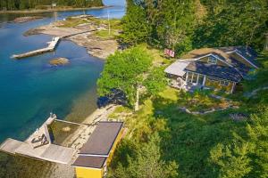 an aerial view of a house on the water at Waterfront Cabin - 15 Minutes from Downtown Oslo in Oslo