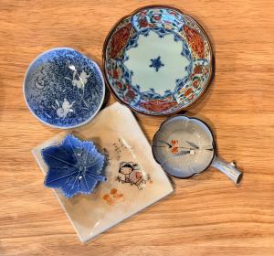 a table with two plates and a cup and a bowl at Fukuchiya in Fujiyoshida