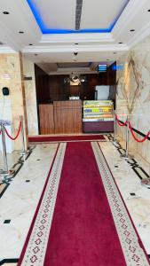 a red carpet in a room with a red carpet at Seasons Apartments in Jazan
