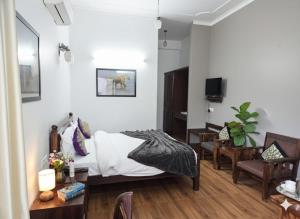 a bedroom with a bed and a table and chairs at The Ranthambore Samrajya Tiger Seven in Sawāi Mādhopur