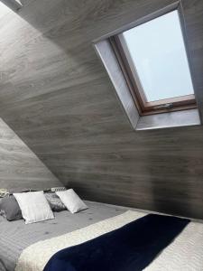 a bedroom with a large bed with a window at Ismail&Stefan in Chişinău +1 photo