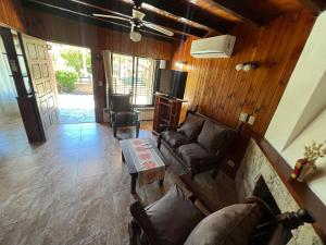 een woonkamer met een bank en een tafel bij Chalet del Sur in Villa Gesell